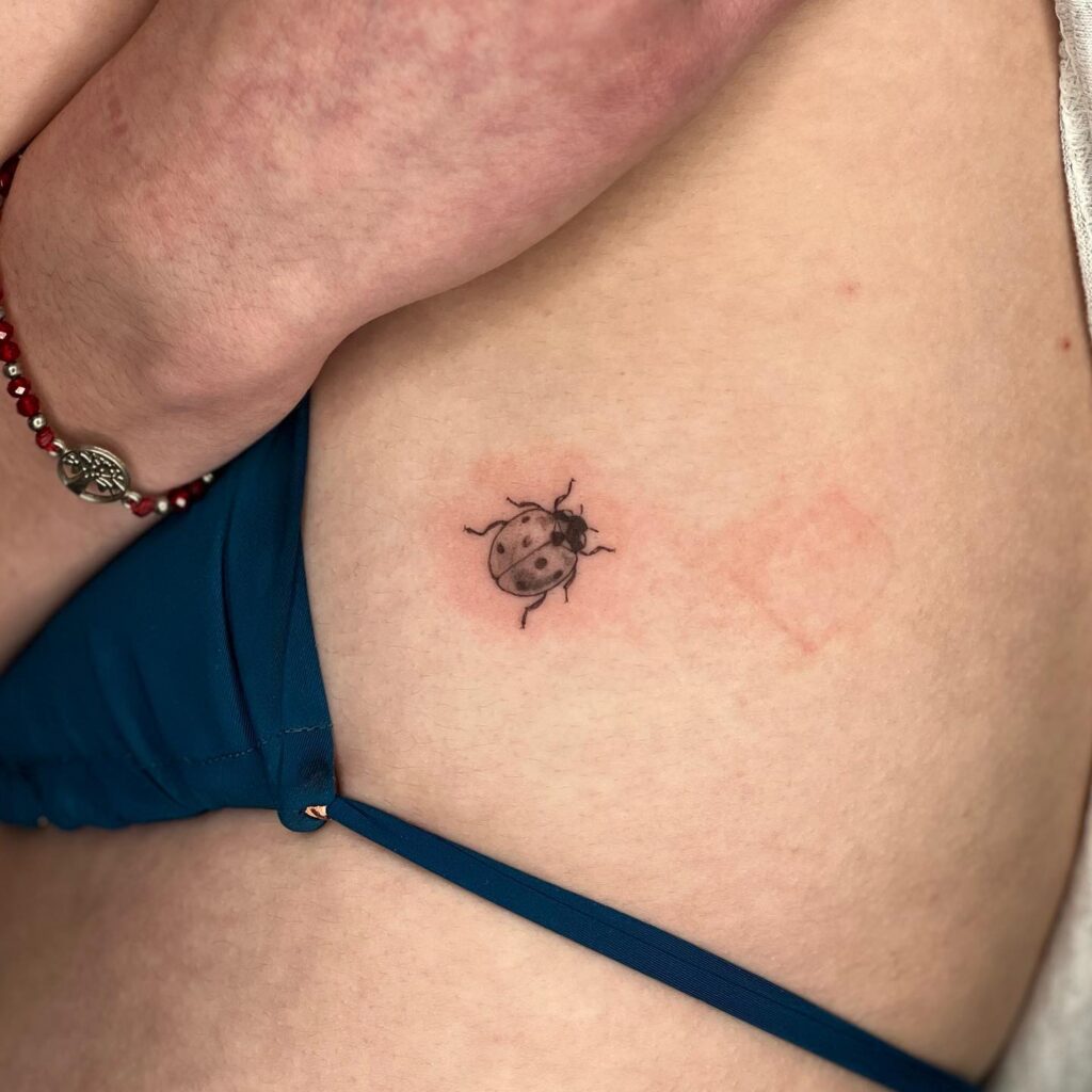 Small and Stylish Creative Rib Ladybug Tattoos for Females Subtle Elegance at its Finest
