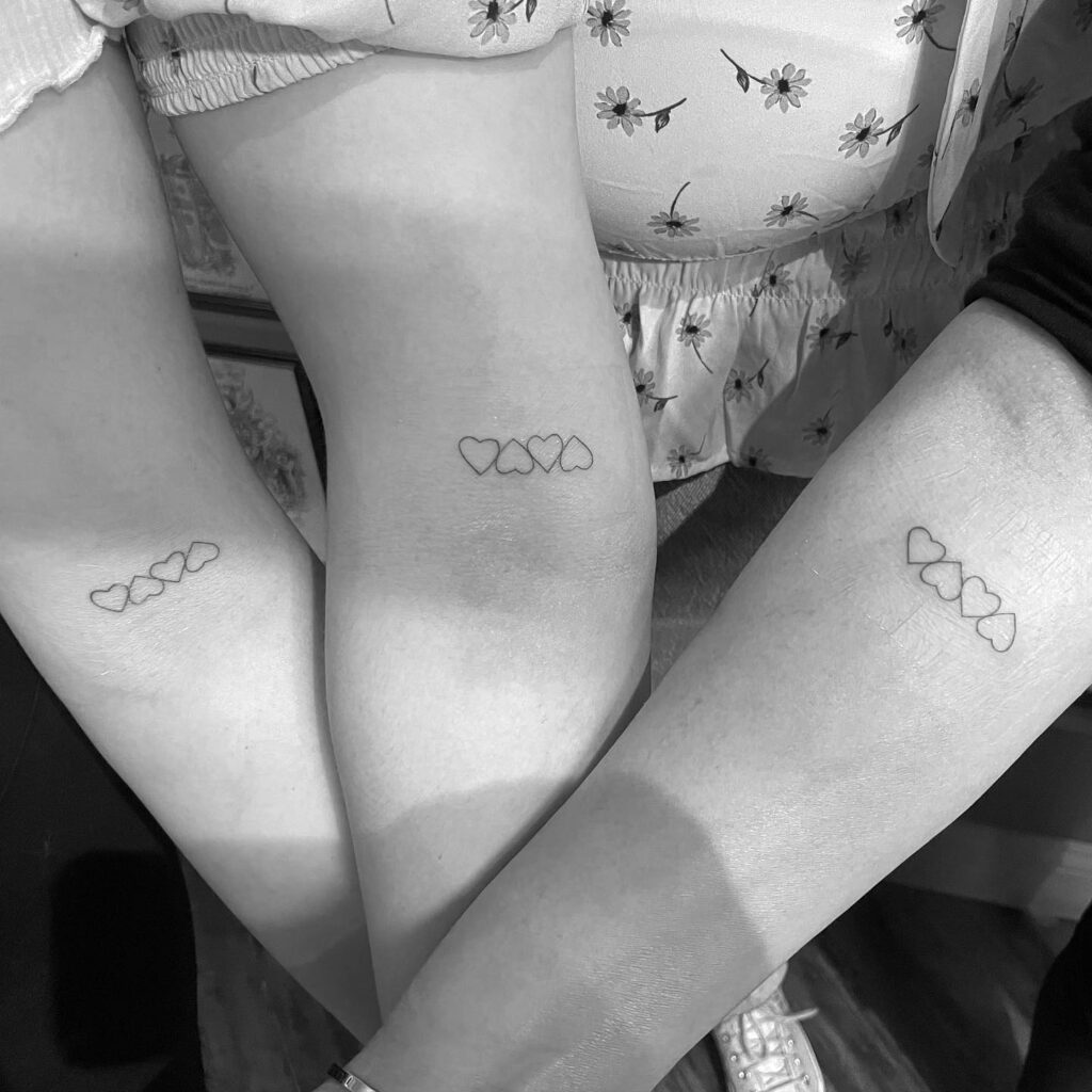Small and simple mother and daughter heart tattoos for a timeless family bond