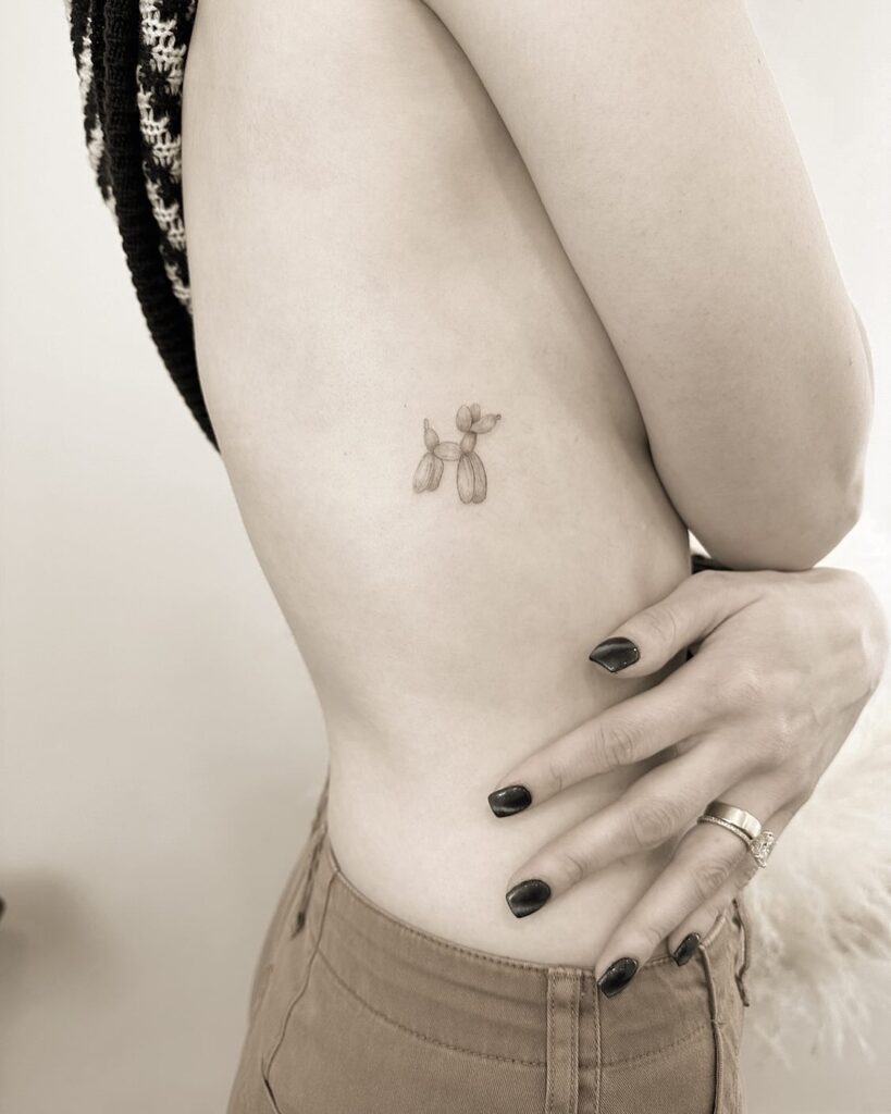 Small Black and Grey Tattoo on the Rib for Females: Bubble Dog Whimsy