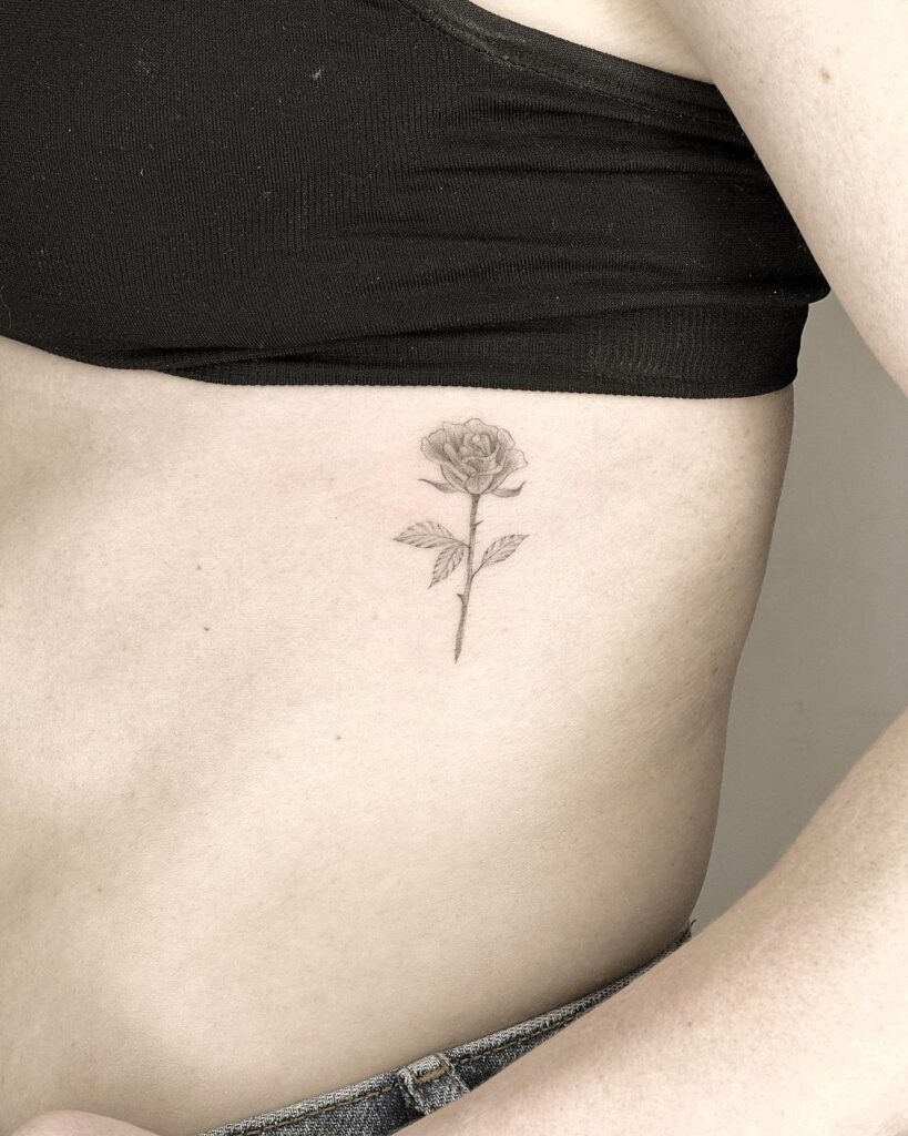 Small black rose tattoo on the left rib cage ribcage roses