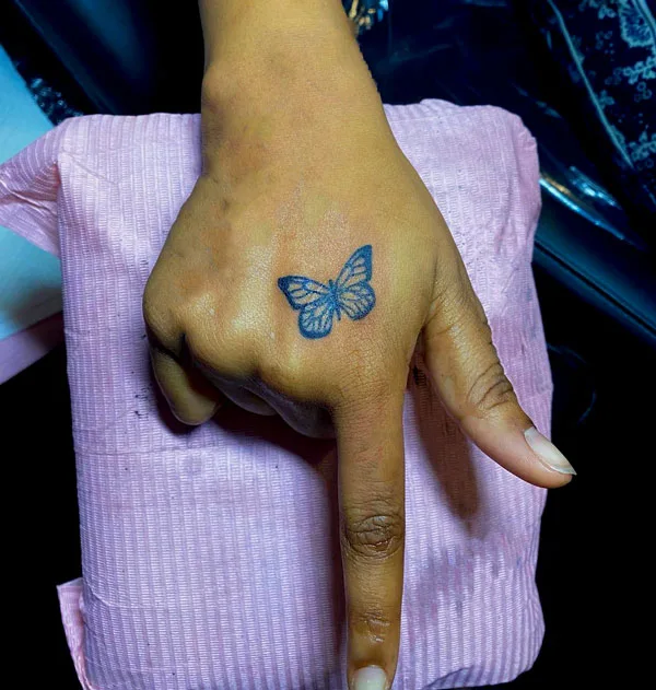 Small butterfly hand tattoo