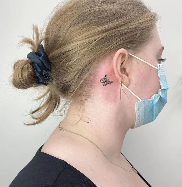 Small butterfly tattoo behind ear