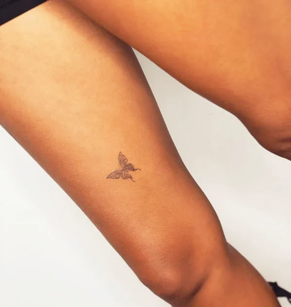 Small butterfly thigh tattoo