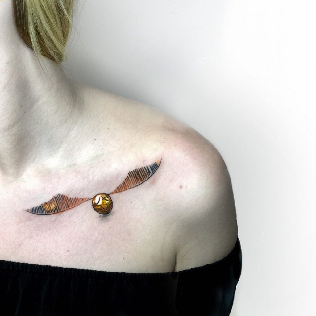 Small cute chest golden snitch tattoo for female delicate charm