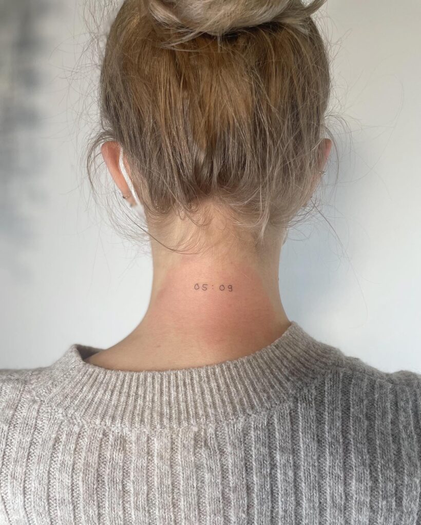 Small date or number tattoo on the back of the neck with personal meaning