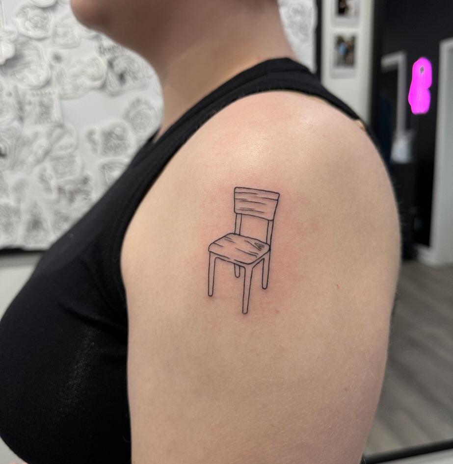 Small Detailed Chair Tattoo on the Upper Arm: Tiny Furniture Accent