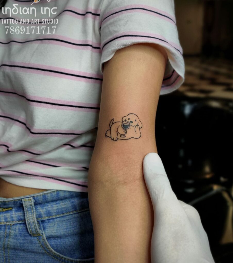 Small Dog Tattoo Above the Elbow with Delicate Lines: Outline Elegance