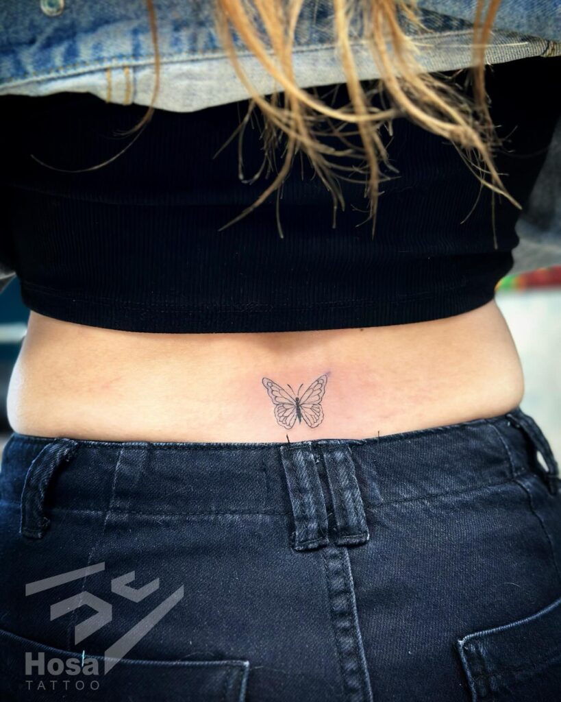 Small Fine Line Tattoo on the Lower Back: Butterfly Finesse