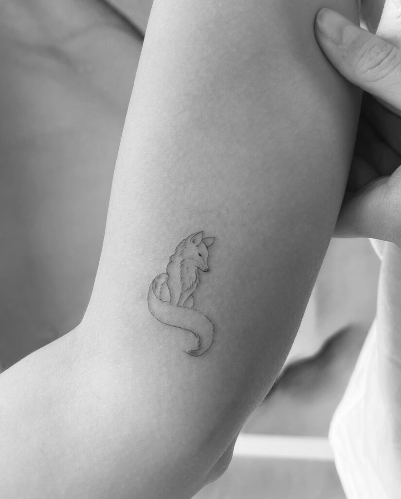 Small Fox Tattoo Above the Elbow Inner, a Little Fox with a Long Tail Sitting: Fineline Fox Fantasy