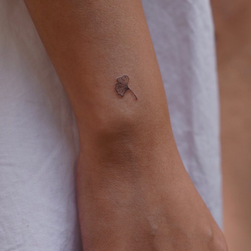 Small ginkgo leaf tattoo on the outer wrist whispers
