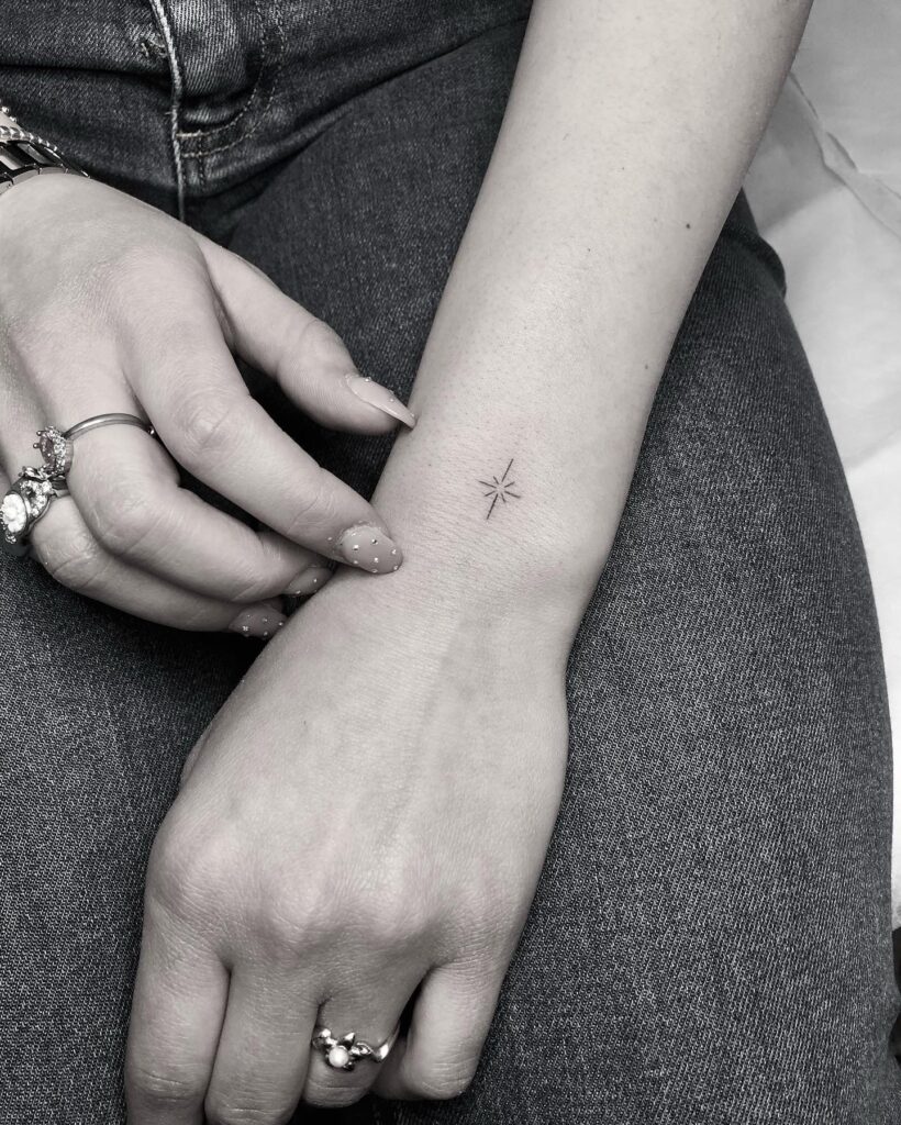 Small minimalist north star tattoo on the outer wrist guiding star