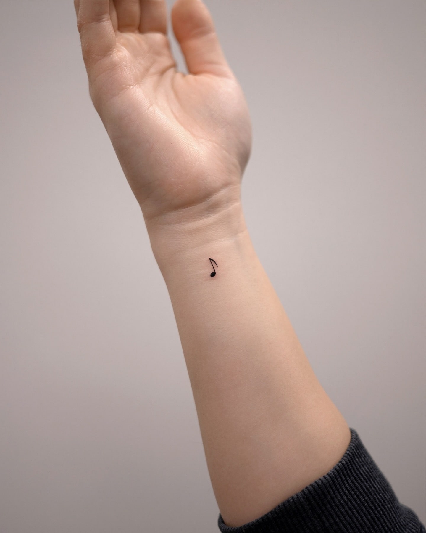 Small Musical Note Wrist Tattoo Symbol of Passion and Creativity