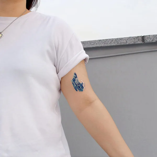 Small ocean wave tattoo