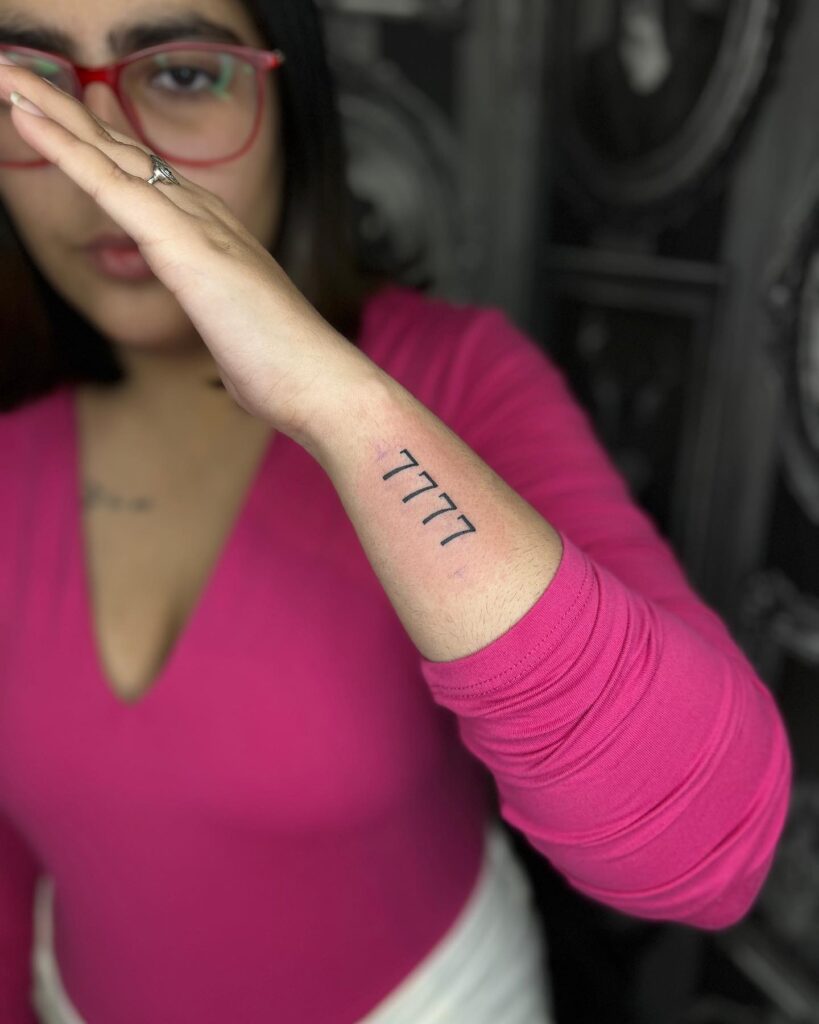 Small outer side forearm tattoo 7777
