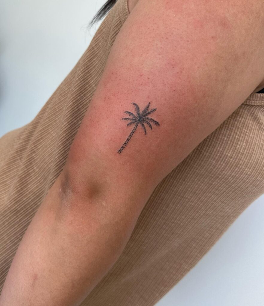 Small Palm Tree Tattoo on the Back of the Elbow: Tropical Breeze