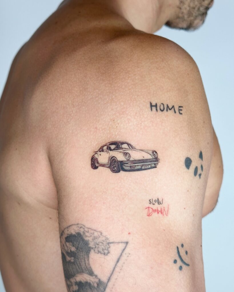 Small Porsche 911 Tattoo on Upper Back Near Shoulder for Men
