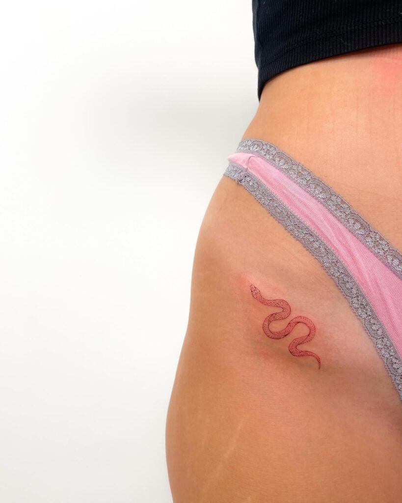 Small Red Snake Tattoo on the Hip for Female, a Serpent's Intriguing Embrace: Crimson Coil