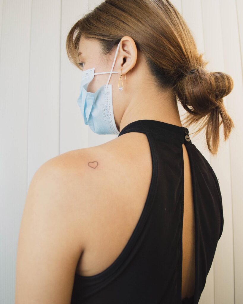 Small shoulder accent outline heart tattoo for her