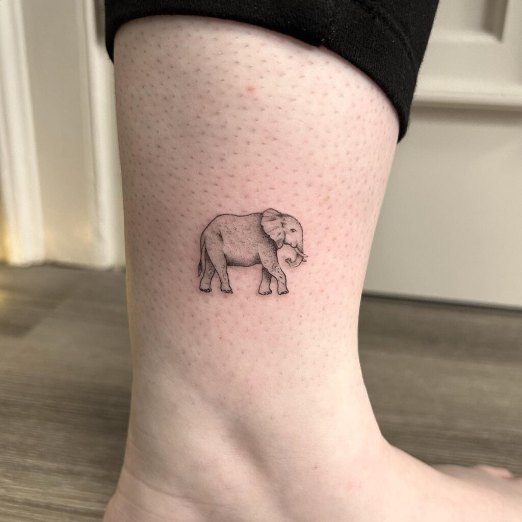 Small simple side view elephant tattoo: cool ankle companion