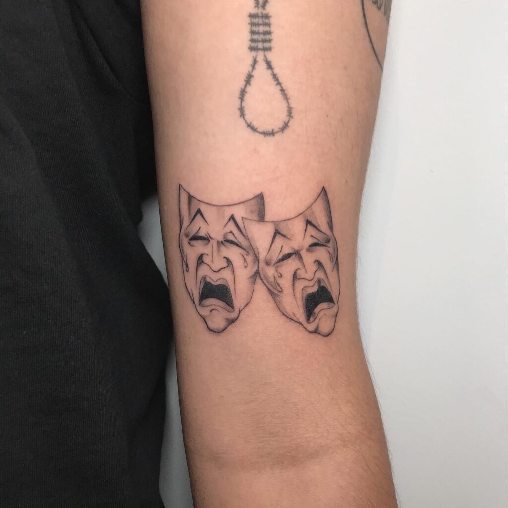 Smile Now Cry Later Mask Tattoo: Above the Elbow Elegance 