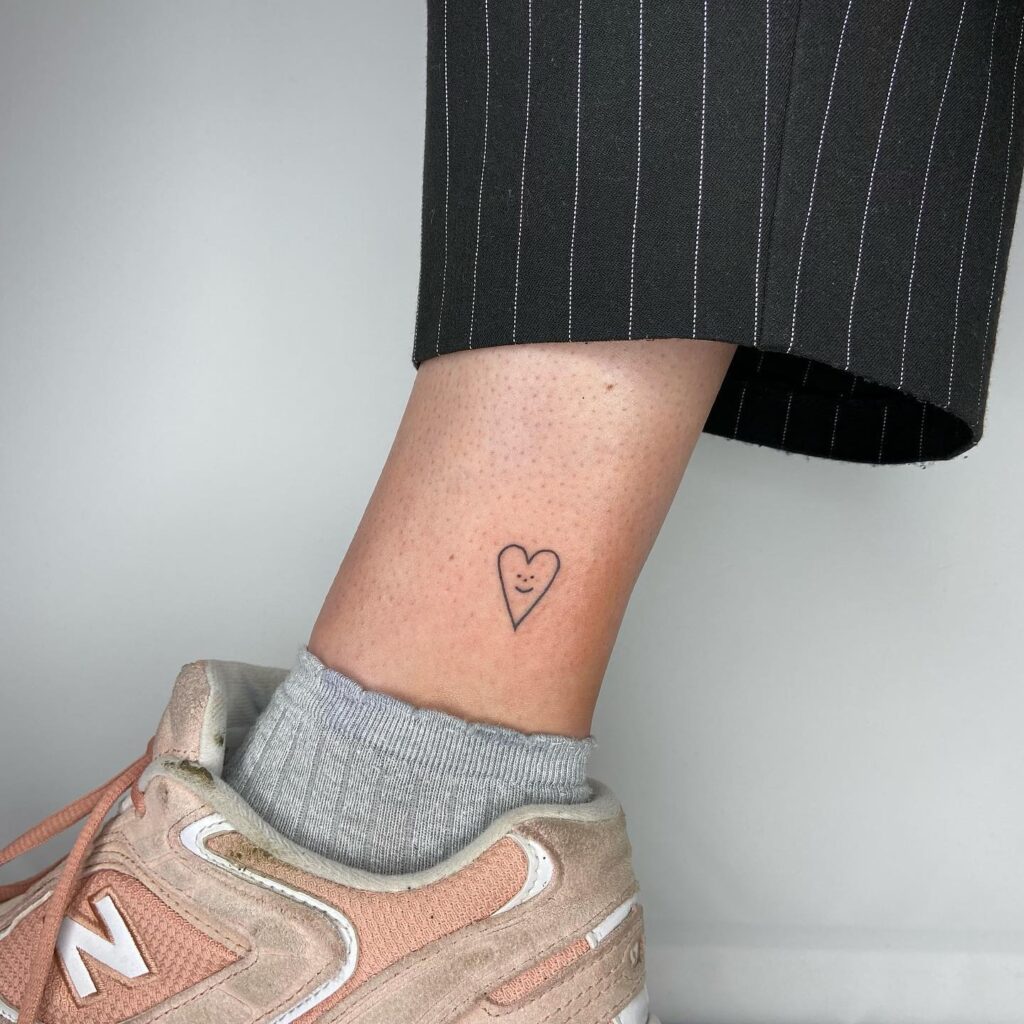 Smiling heart outline heart with inside smile face near the ankle