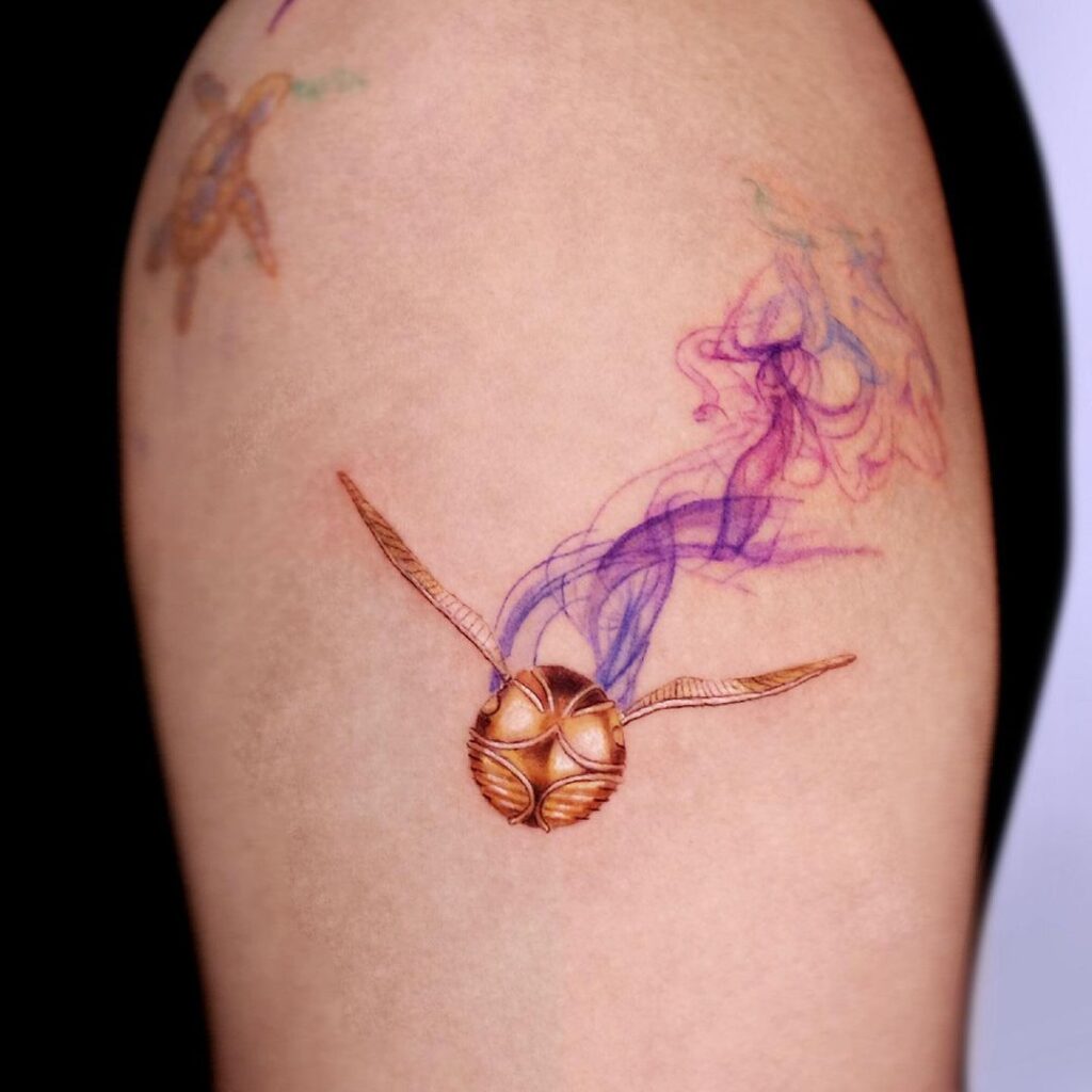 Smoky golden snitch tattoo image