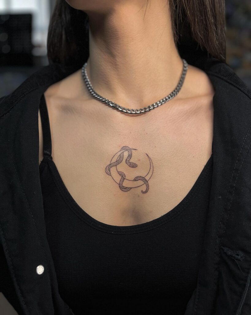 Snake and crescent moon collarbone tattoo: A small and mystical design