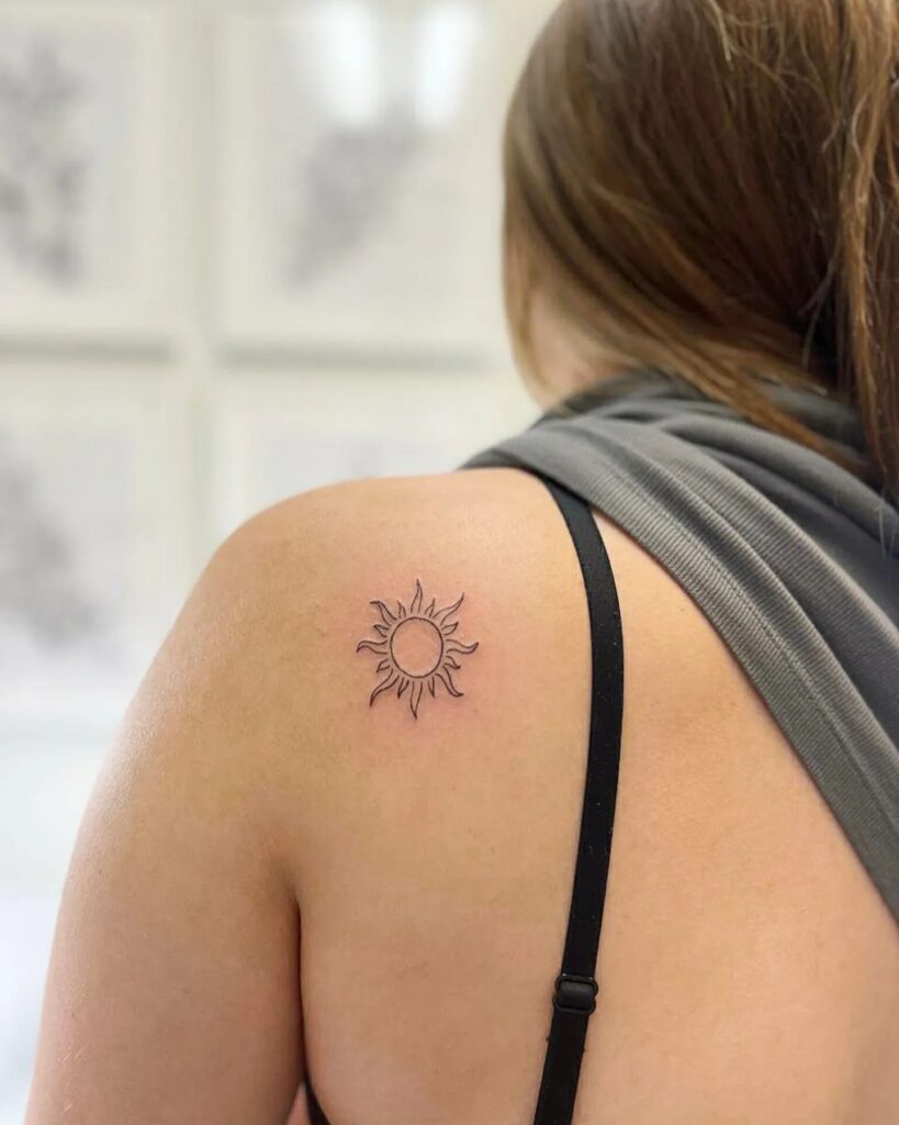 Solar radiance detailed sun tattoo on the shoulder blade