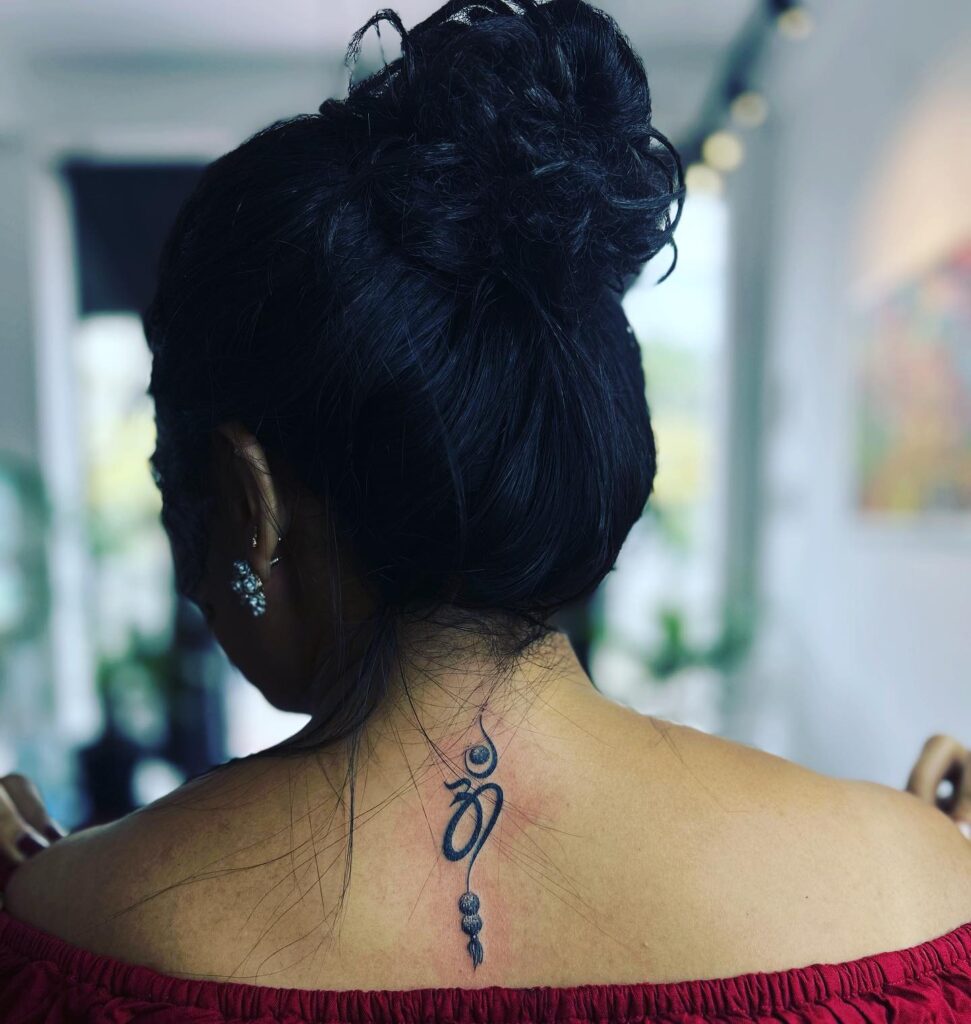 Soulful serenity unique om symbol tattoo for ladies on the nape of the neck
