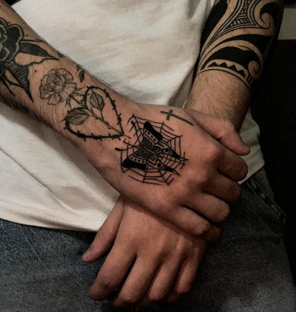 Spider web butterfly hand tattoo