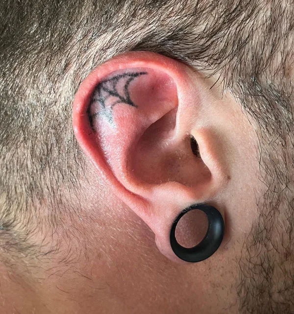 Spider web ear tattoo