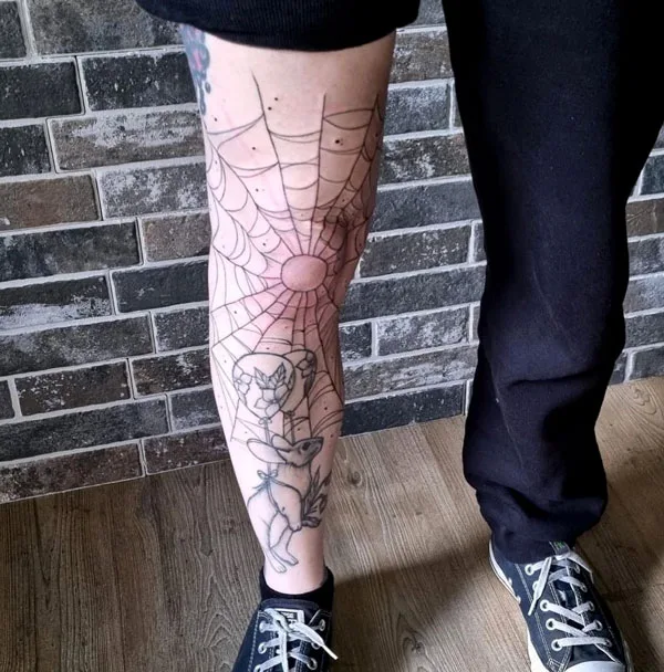 Spider web knee tattoo
