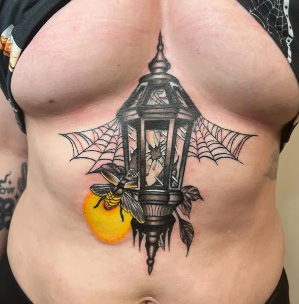 Spider web sternum tattoo