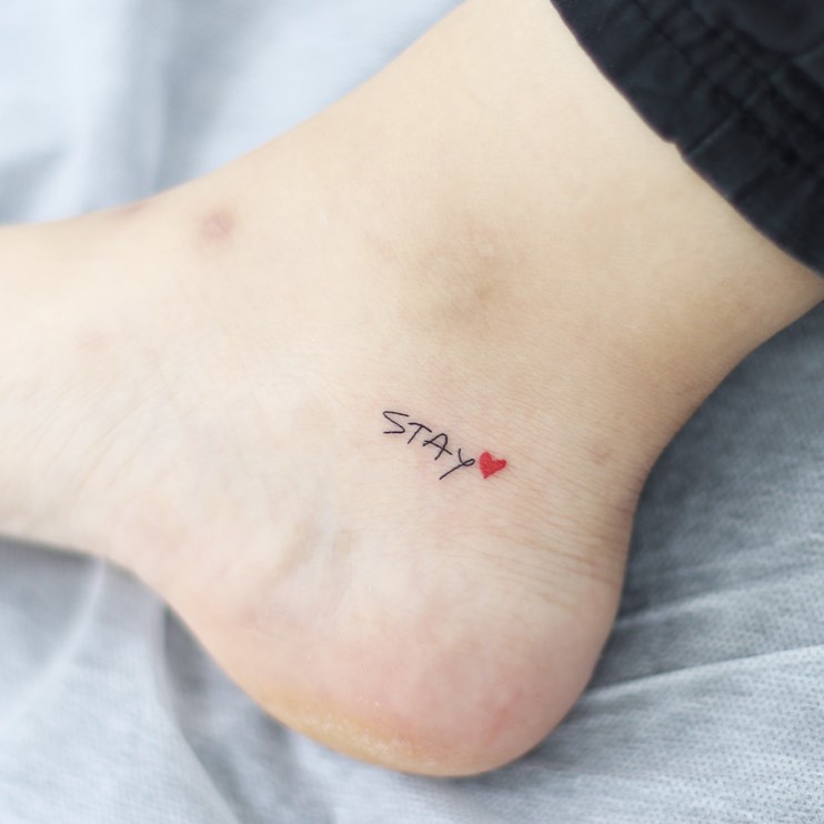 Stay with a red heart a simple foot tattoo
