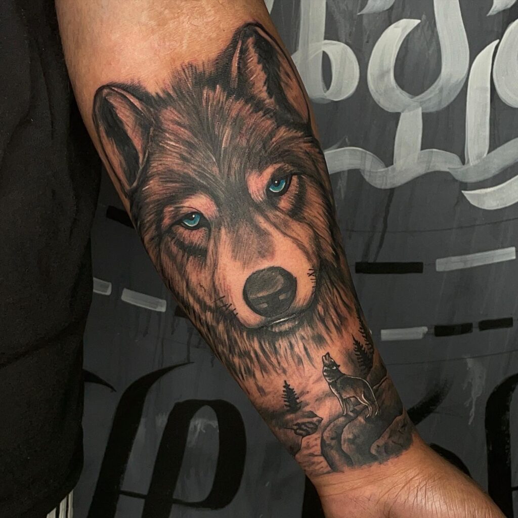 Striking forearm tattoo design blue-eyed wolf howling