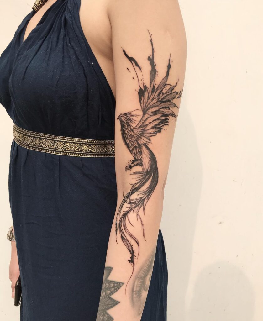 Stunning and Bold Phoenix Rising Sleeve Tattoo Embracing Resilience