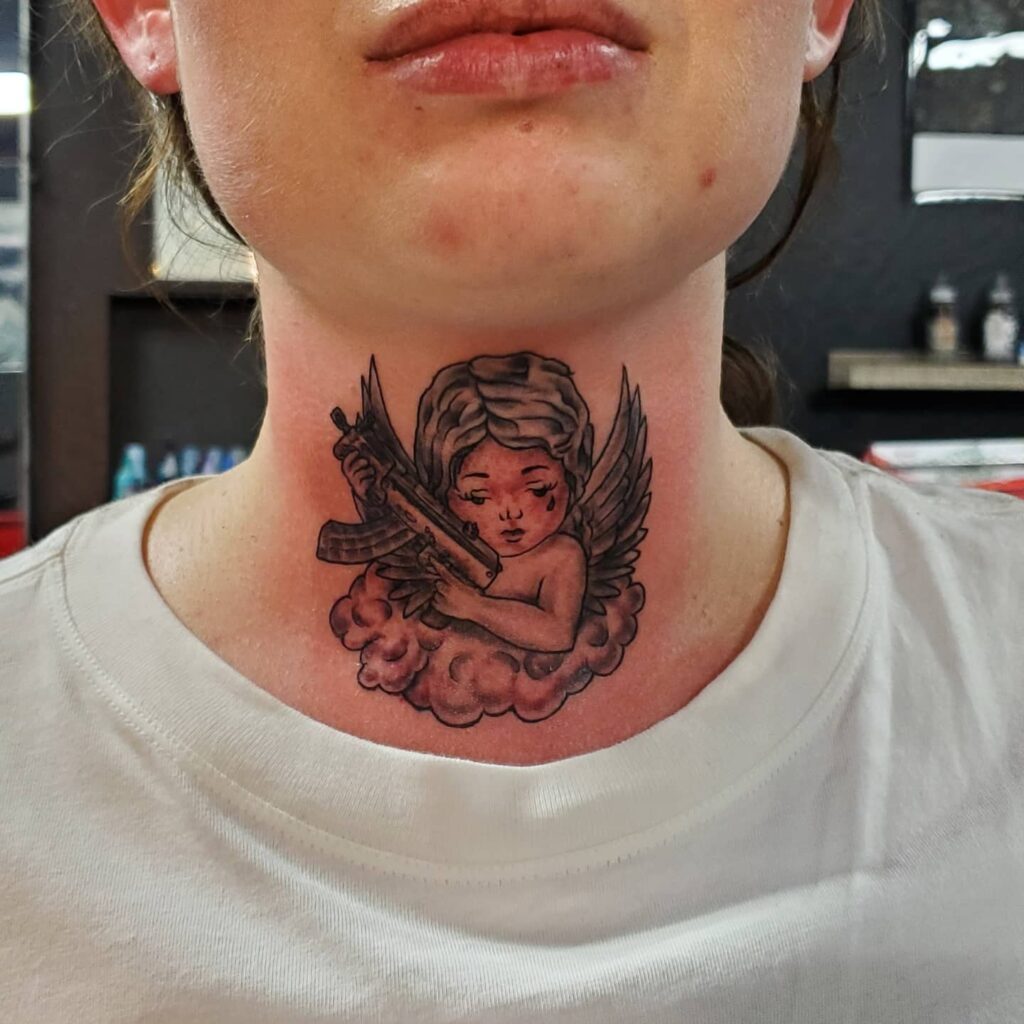 Stunning angel with gun on the front neck tattoo for females a bold choice in body art