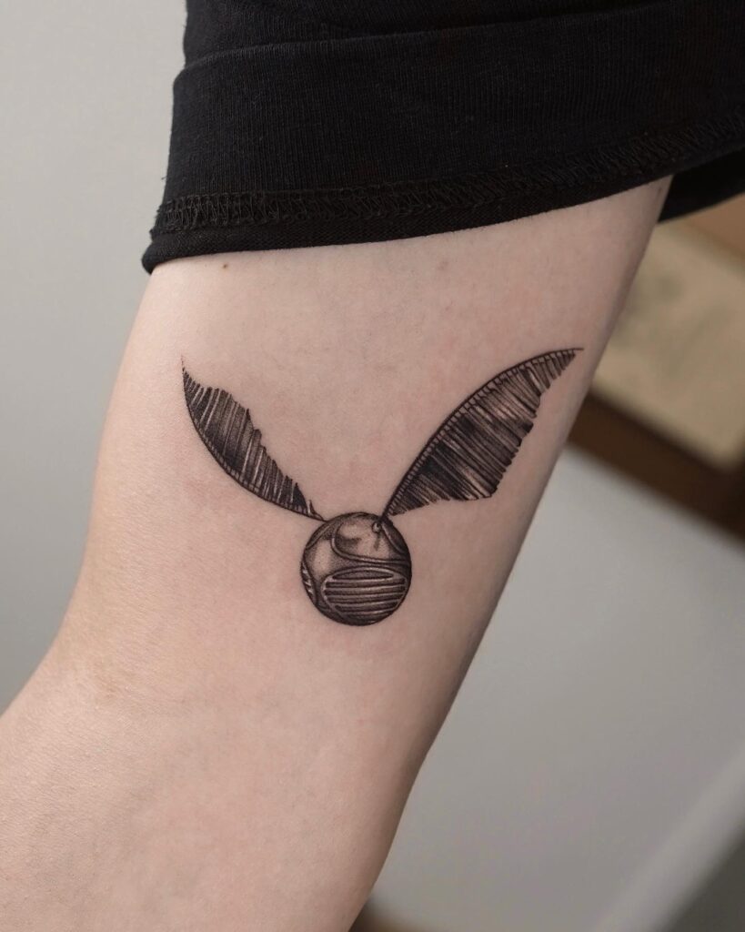 Stunning arm magic golden snitch tattoo ideas for females