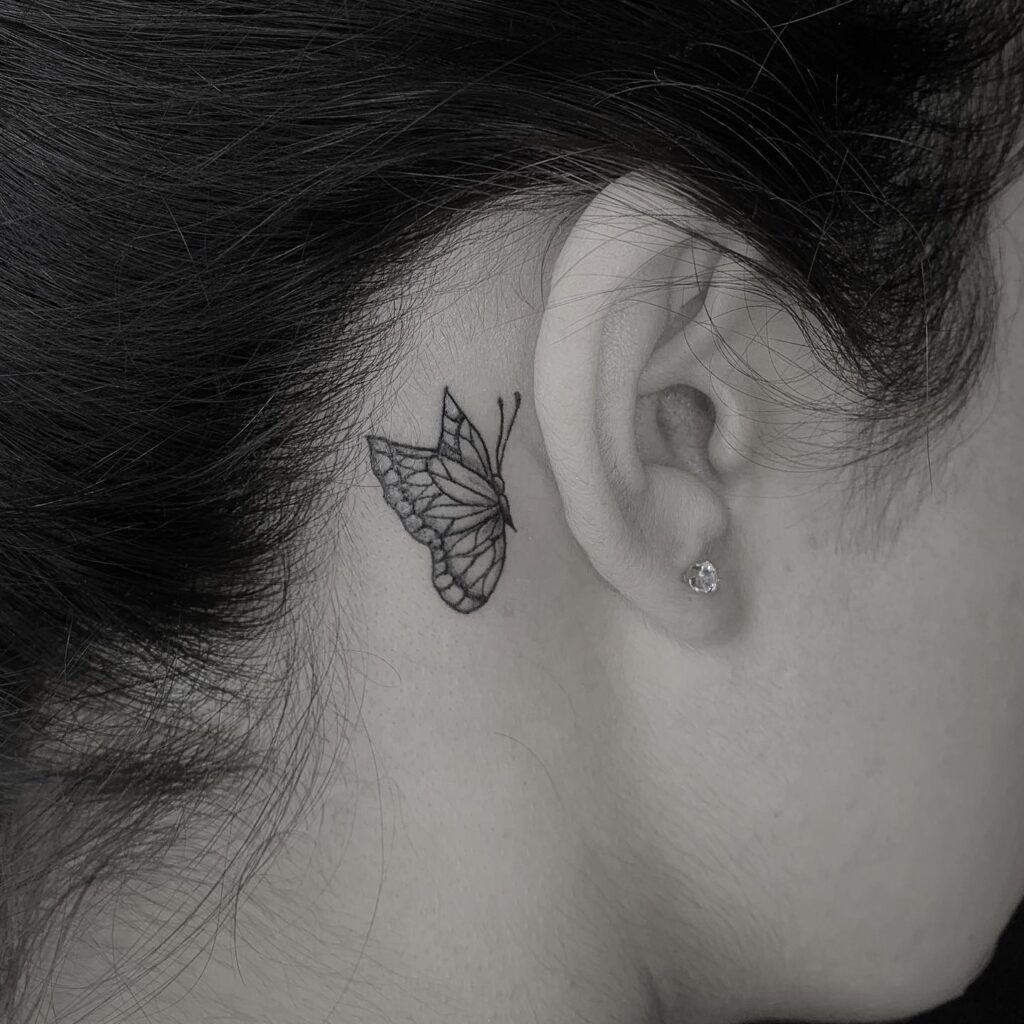 Stunning fine line elegance butterfly tattoo behind the ear
