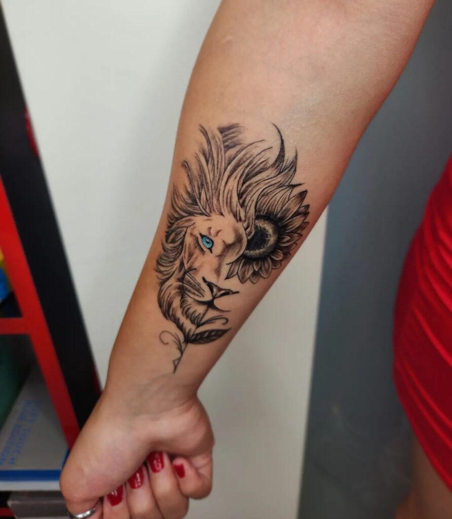 Stunning half face lion and half sunflower tattoo on the forearm for women, with the lion boasting captivating blue eyes floral fusion