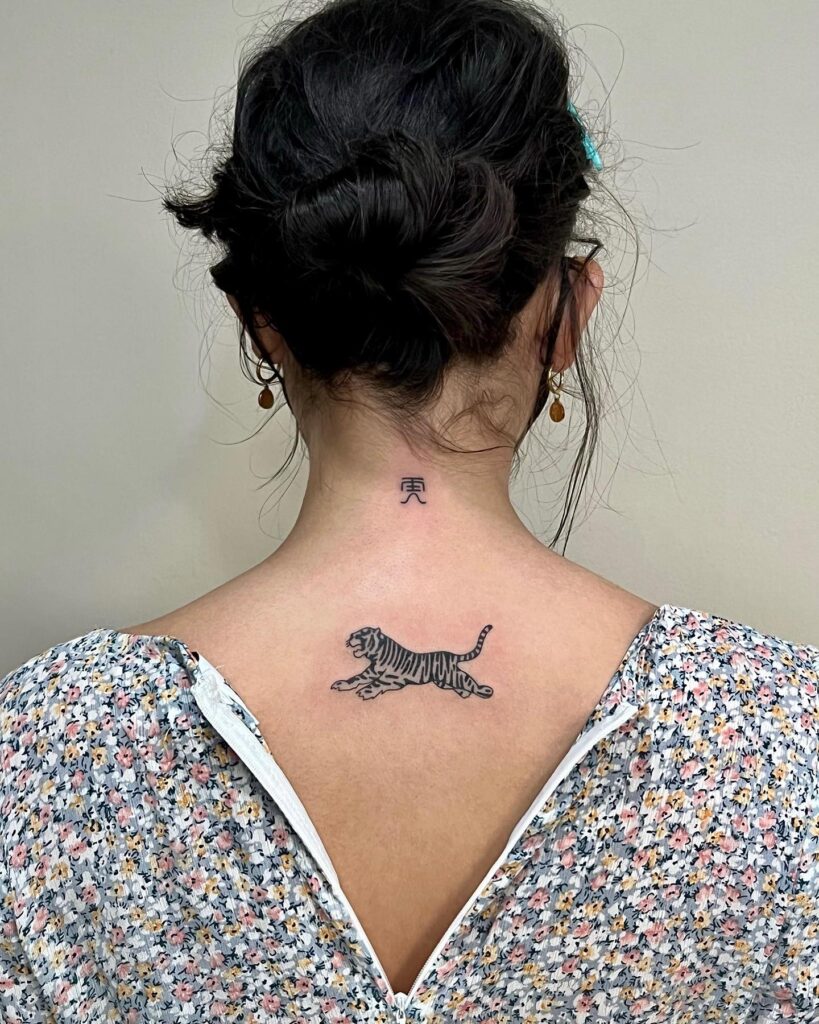 Stunning small jumping tiger tattoo on the back graceful leap