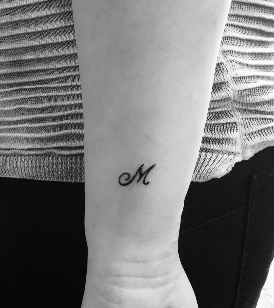 Stylish 'M' Tattoo on the Side of the Wrist: Wrist Statement