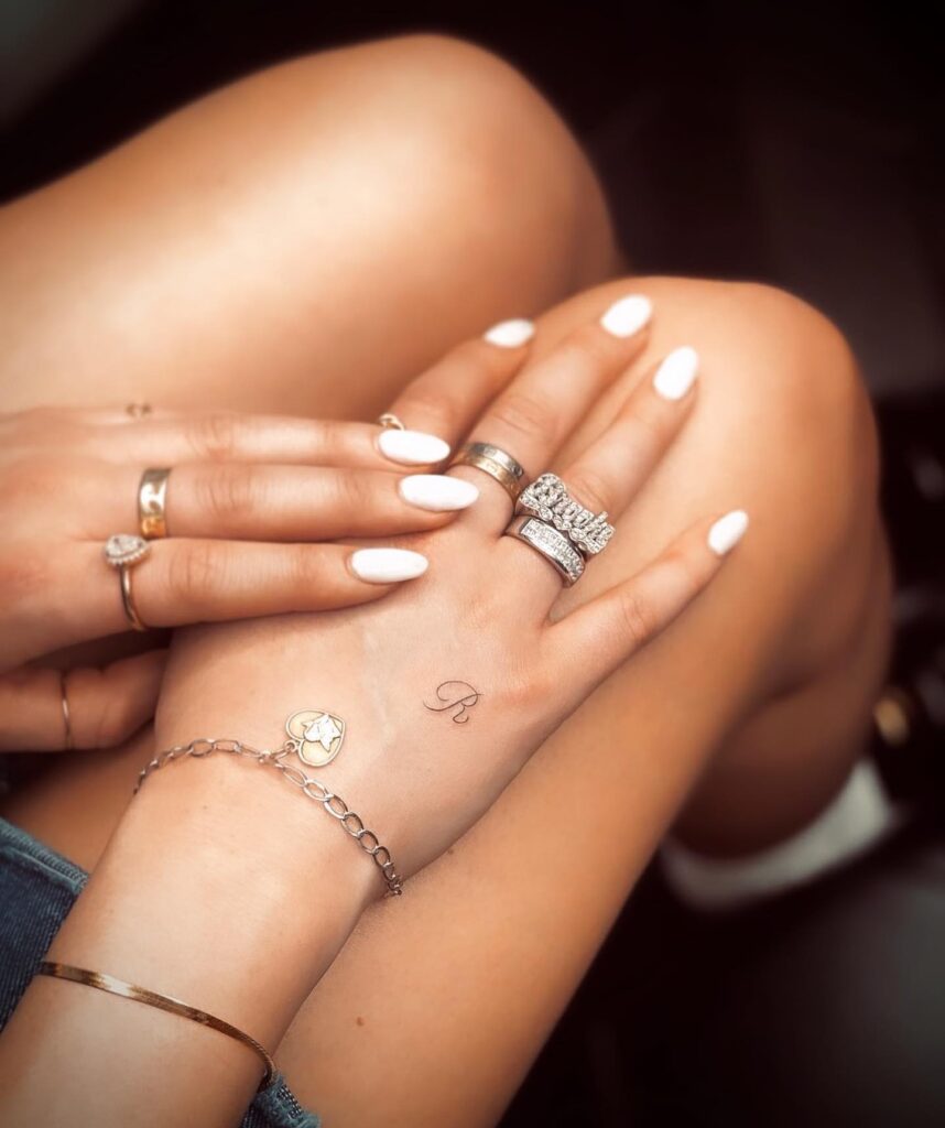 Stylish 'R' Letter Tattoo on the Outer Hand: Handcrafted Elegance