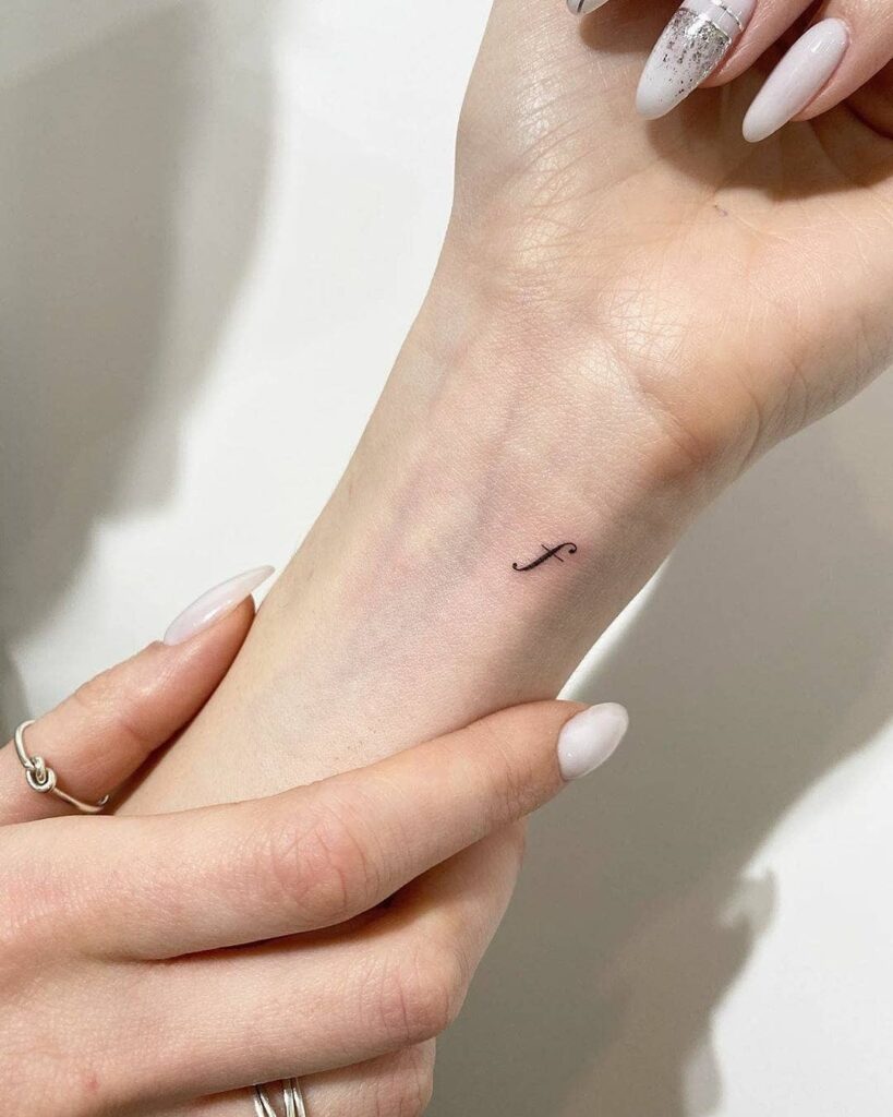 Stylish f lettering tattoo on the inner wrist personalized ink