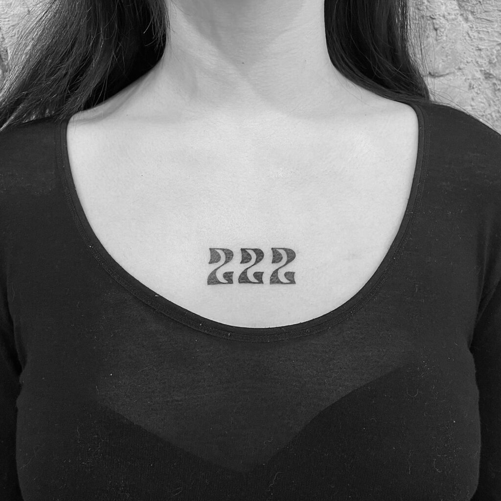 Stylish Text 222 Angel Number Tattoo on the Chest for Females, an Elegant Emblem: Chest of Serenity 