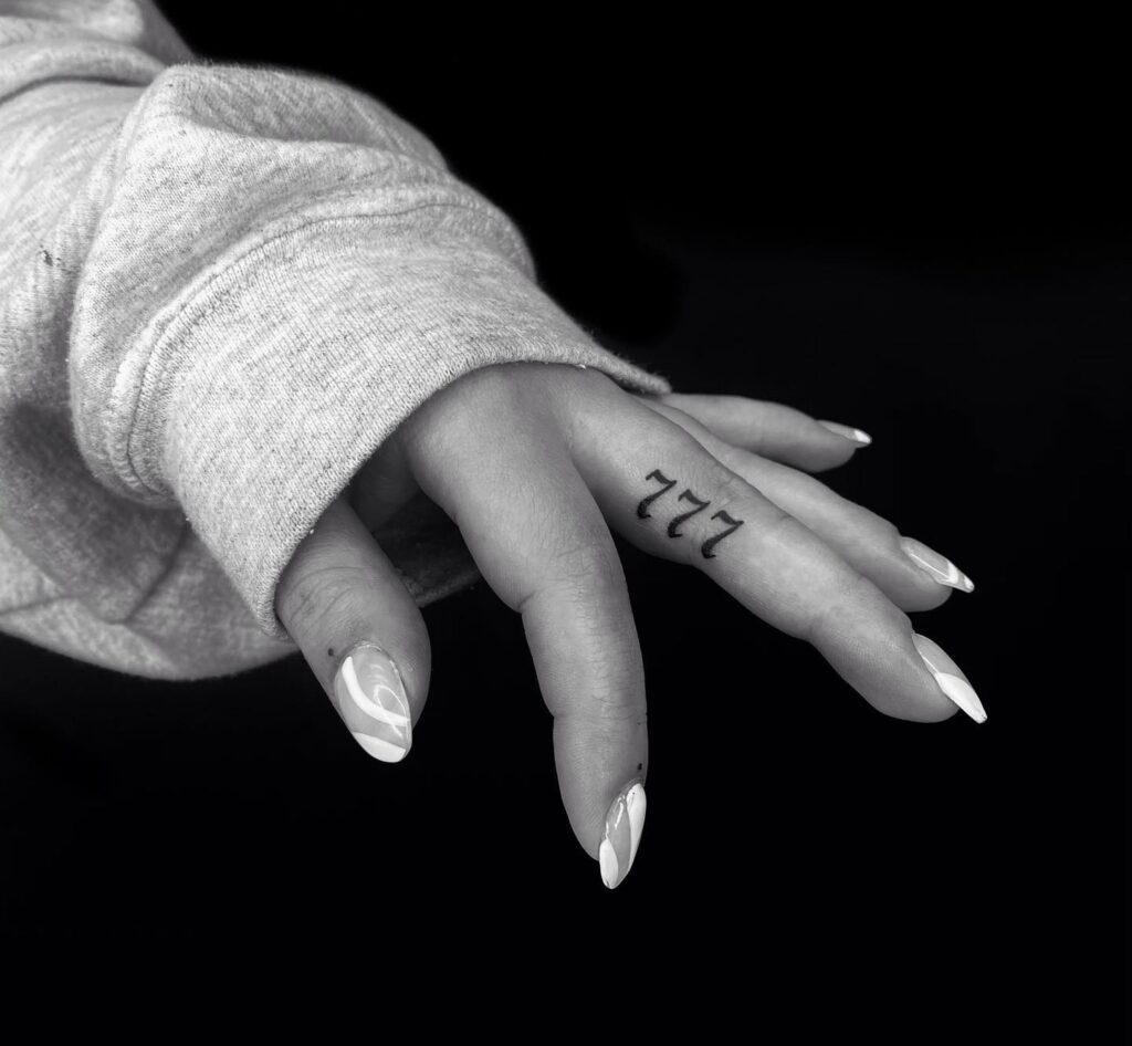Subtle 777 Number Tattoo on the Side of the Middle Finger: Finger Whispers 