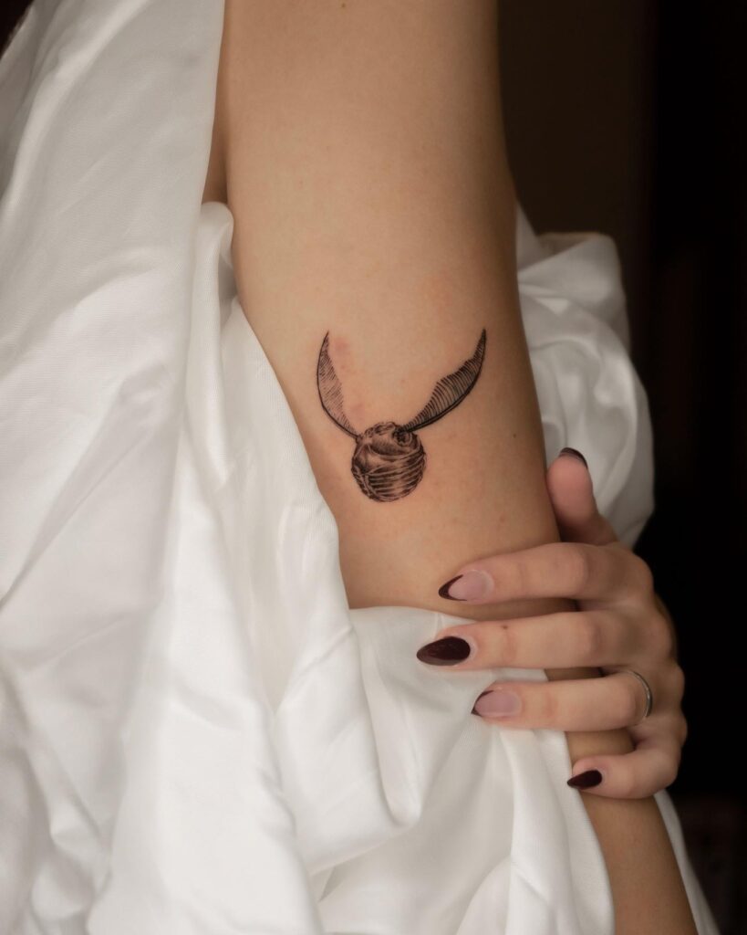 Subtle Charm Elbow Snitch Tattoo for the Minimalist image