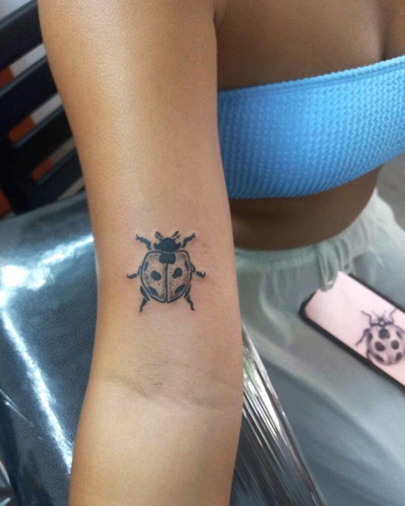 Subtle beauty cool inner above elbow ladybug tattoo