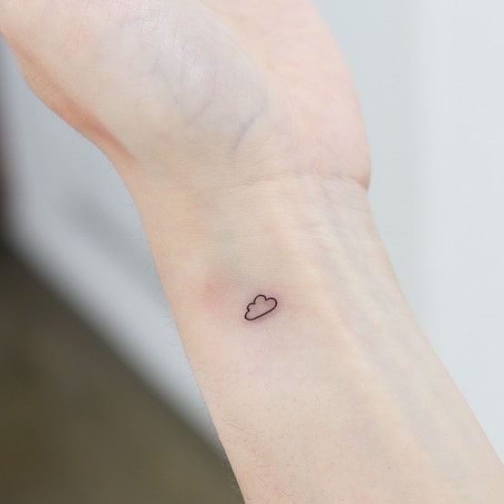 Subtle cloud outline tattoo on inner wrist unveil the elegance of tiny and delicate wrist art