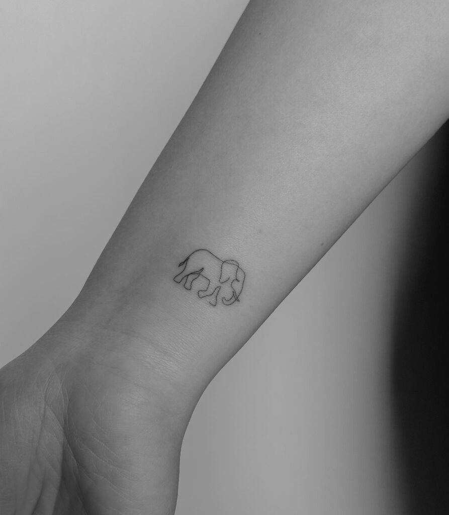 Subtle outline elephant tattoo for a delicate touch: tiny wrist adornment